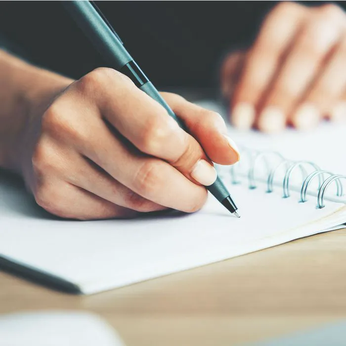woman writing in journal