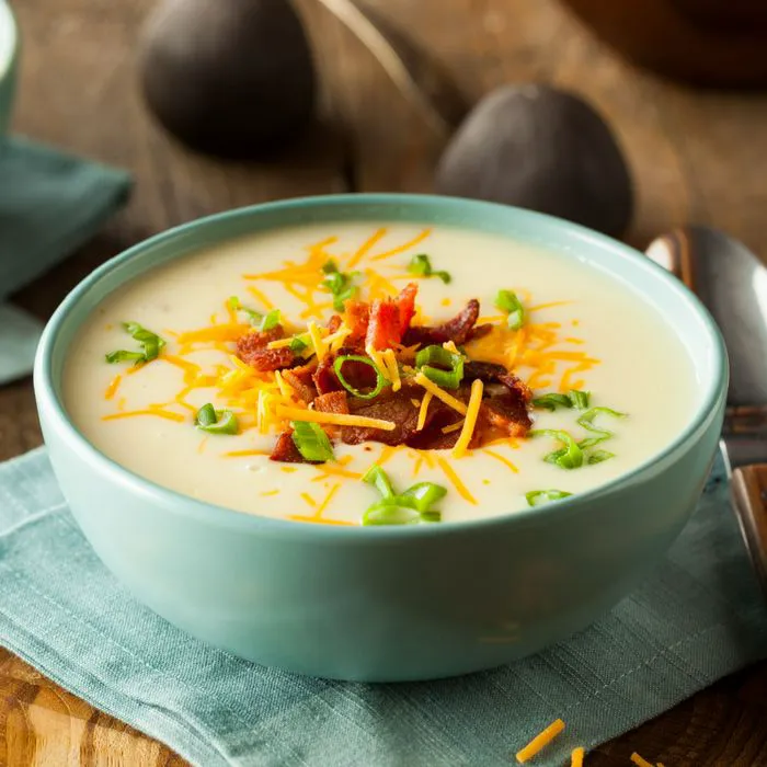 bowl of cream of potato soup topped with cheese and bacon