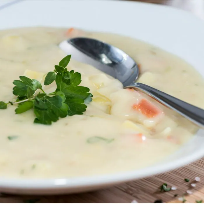 bowl of potato soup with spoon in it