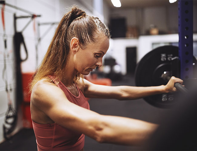 woman strength training at gym