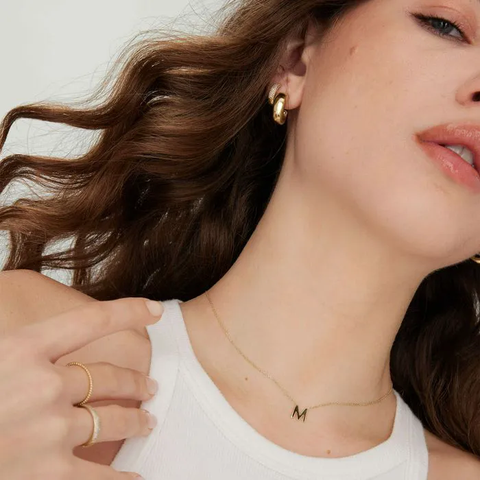 14K letter station necklaces stacked elegantly
