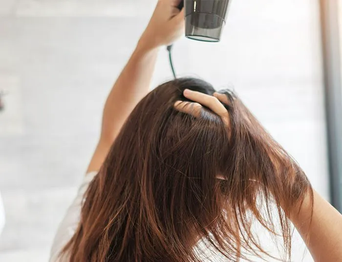 woman-blow-drying-hair