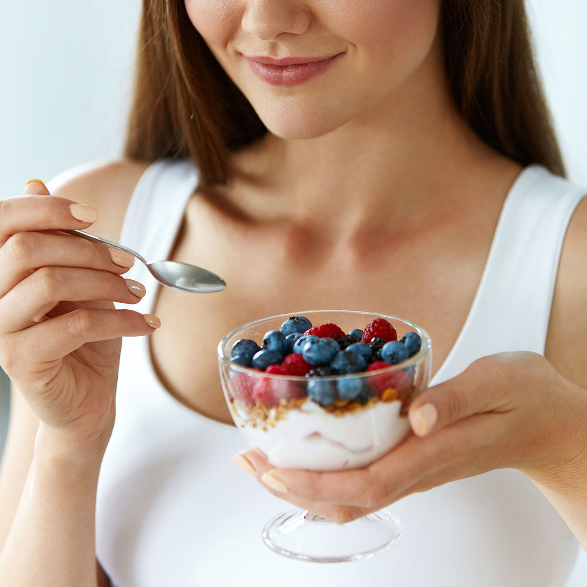 woman eating yogurt parfait