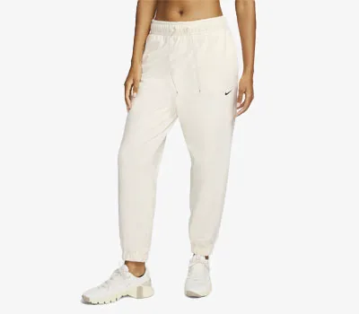 Women's loose fleece pants designed with Therma-FIT by Nike.