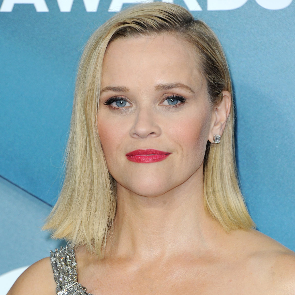 Reese Witherspoon shows off her toned legs in orange shorts after