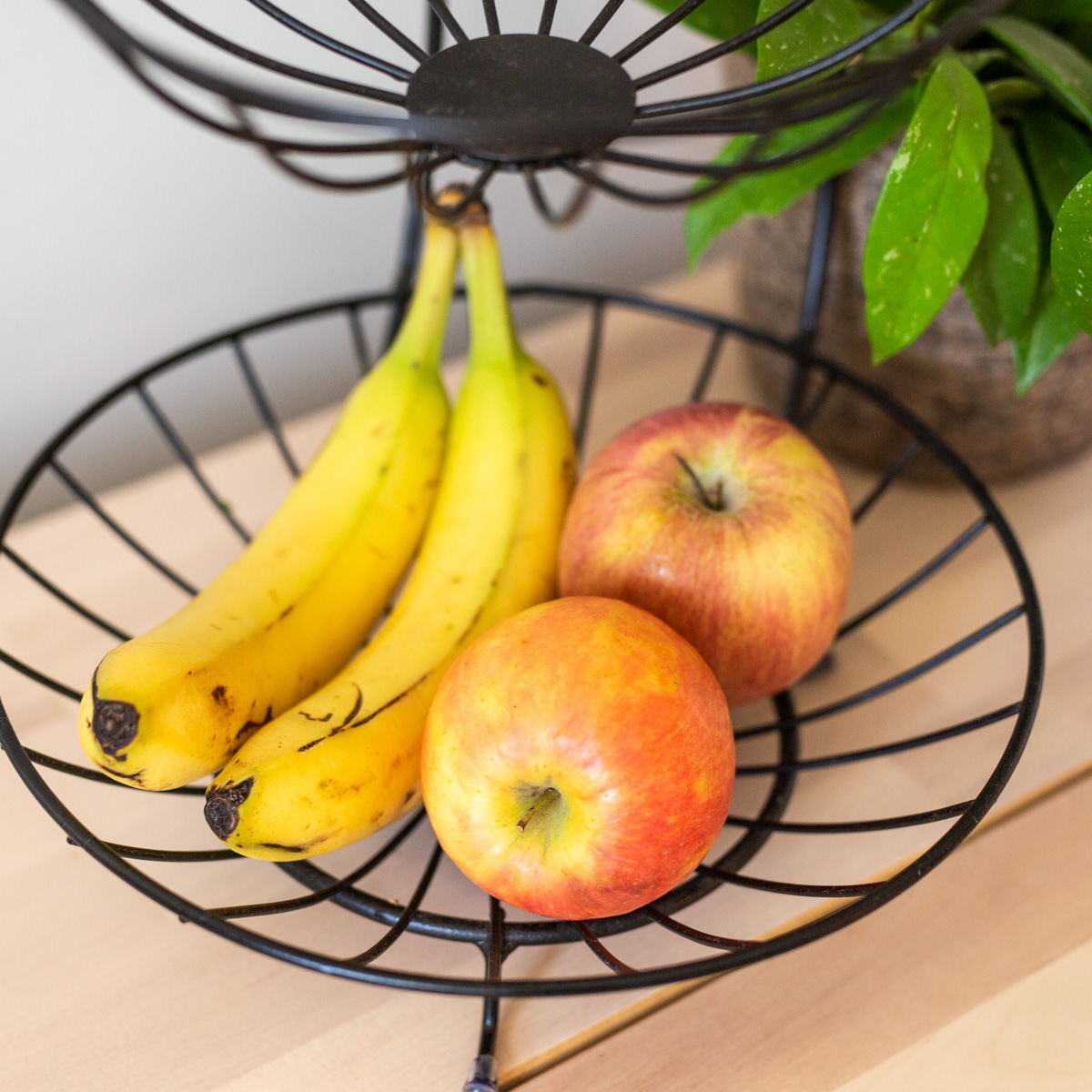 apples and bananas in fruit basket