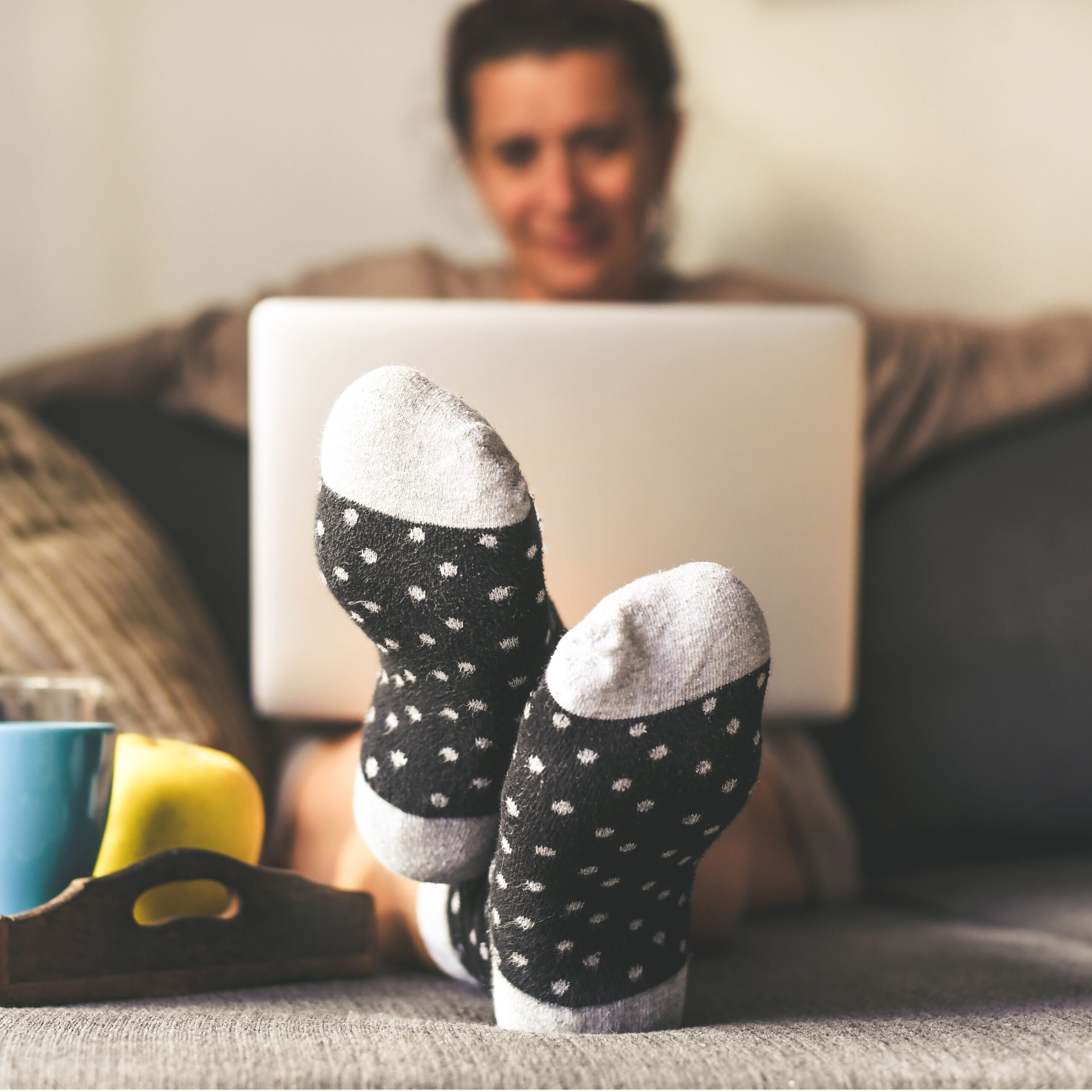 woman sitting on couch on laptop