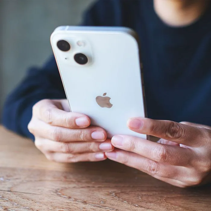 Woman using iPhone to browse beauty products