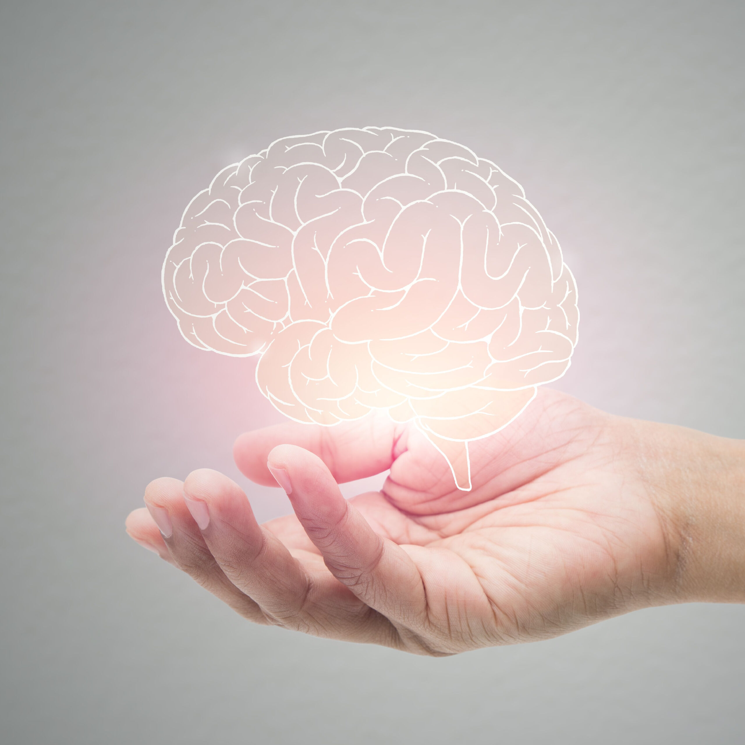 hand holding illuminated brain illustration