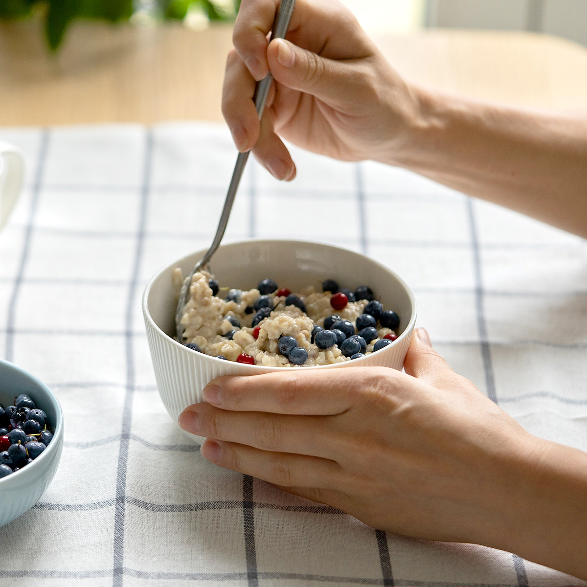 woman eating bowl of oatmeal