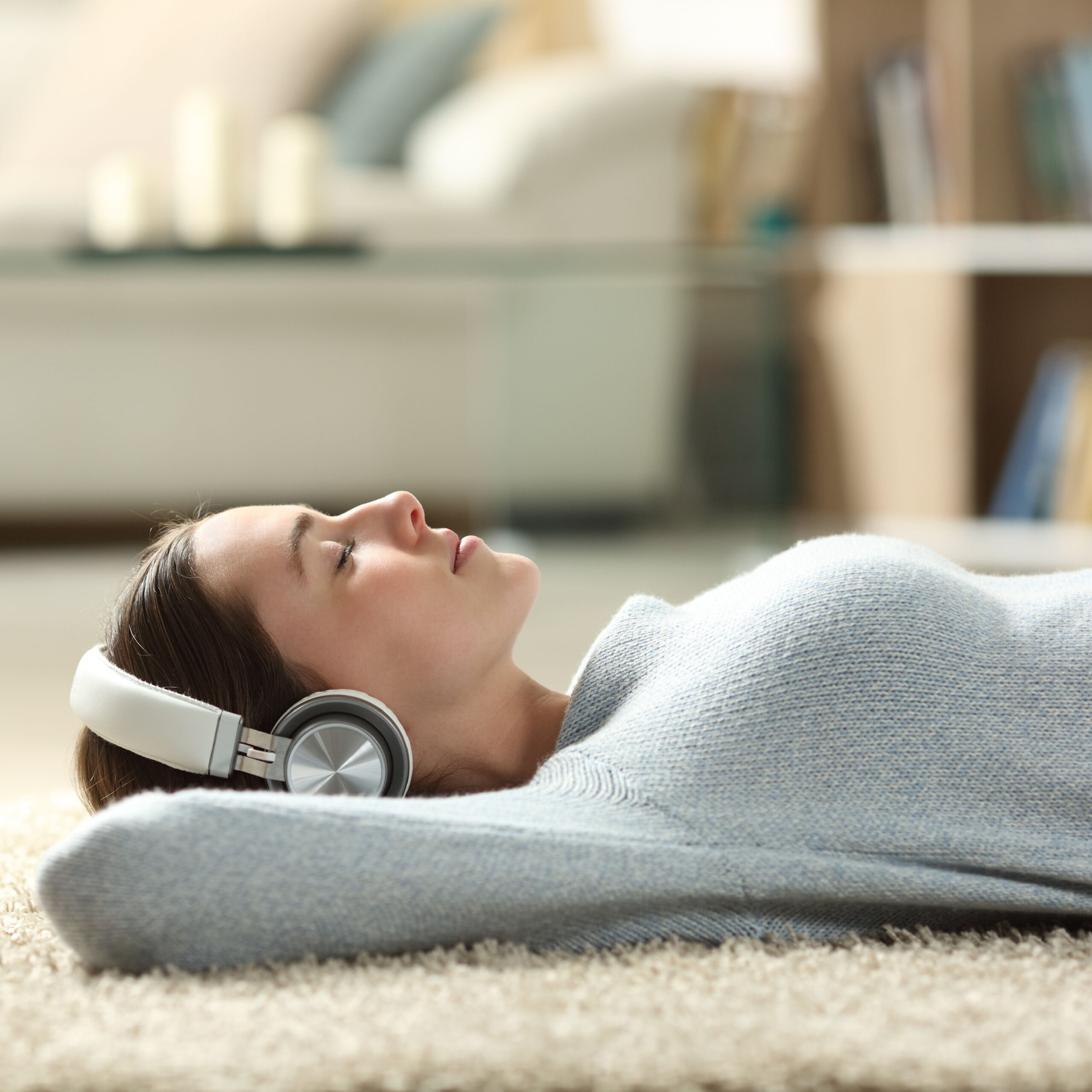 woman lying on floor with headphones on
