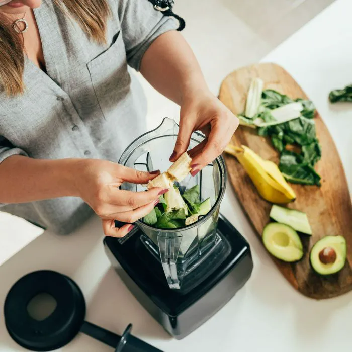 woman making smoothie