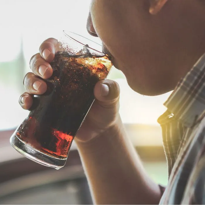 man drinking soda