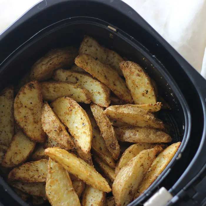 "Air-fried potato wedges in a basket"