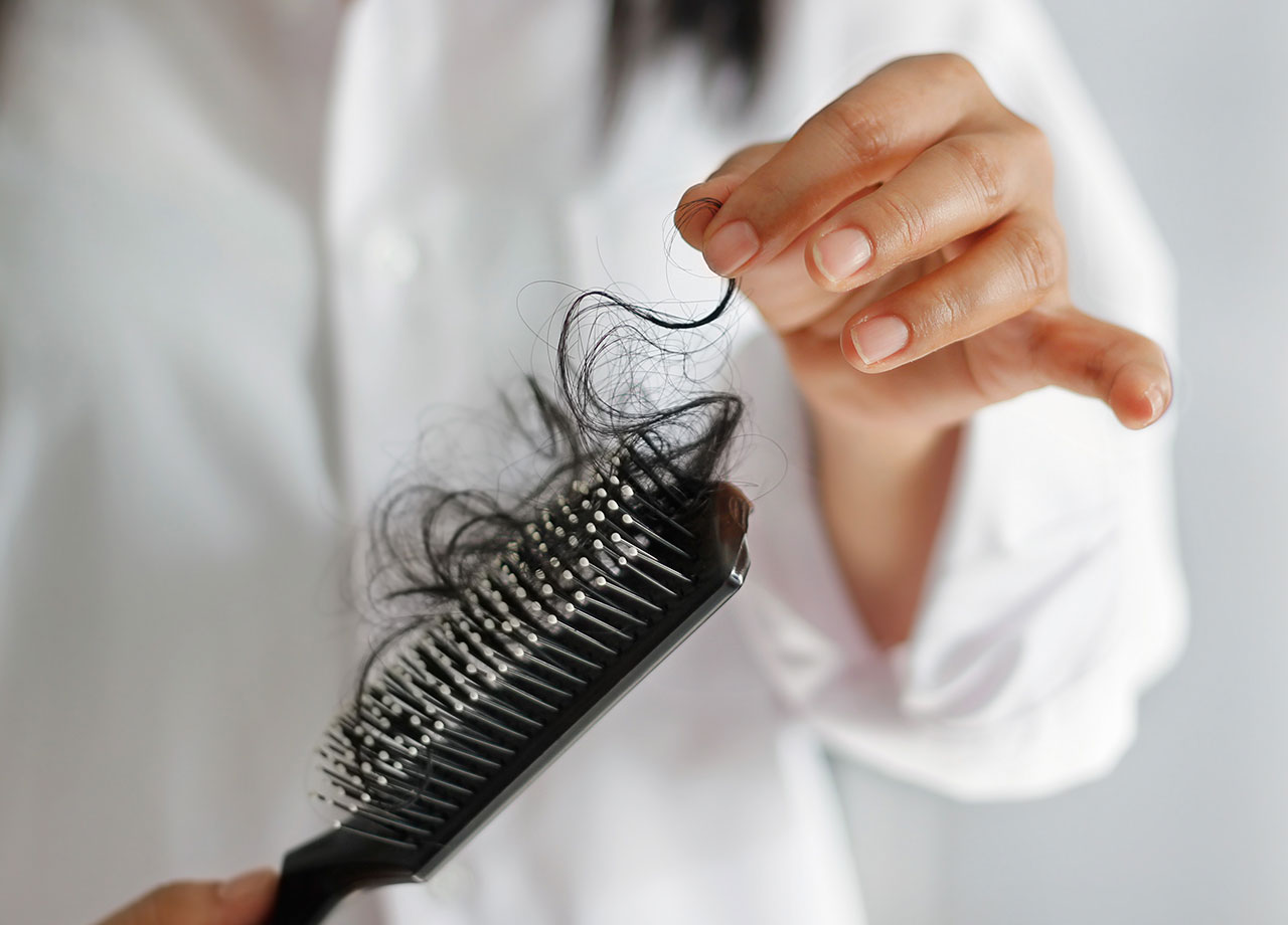 woman-pulling-hair-from-hairbrush