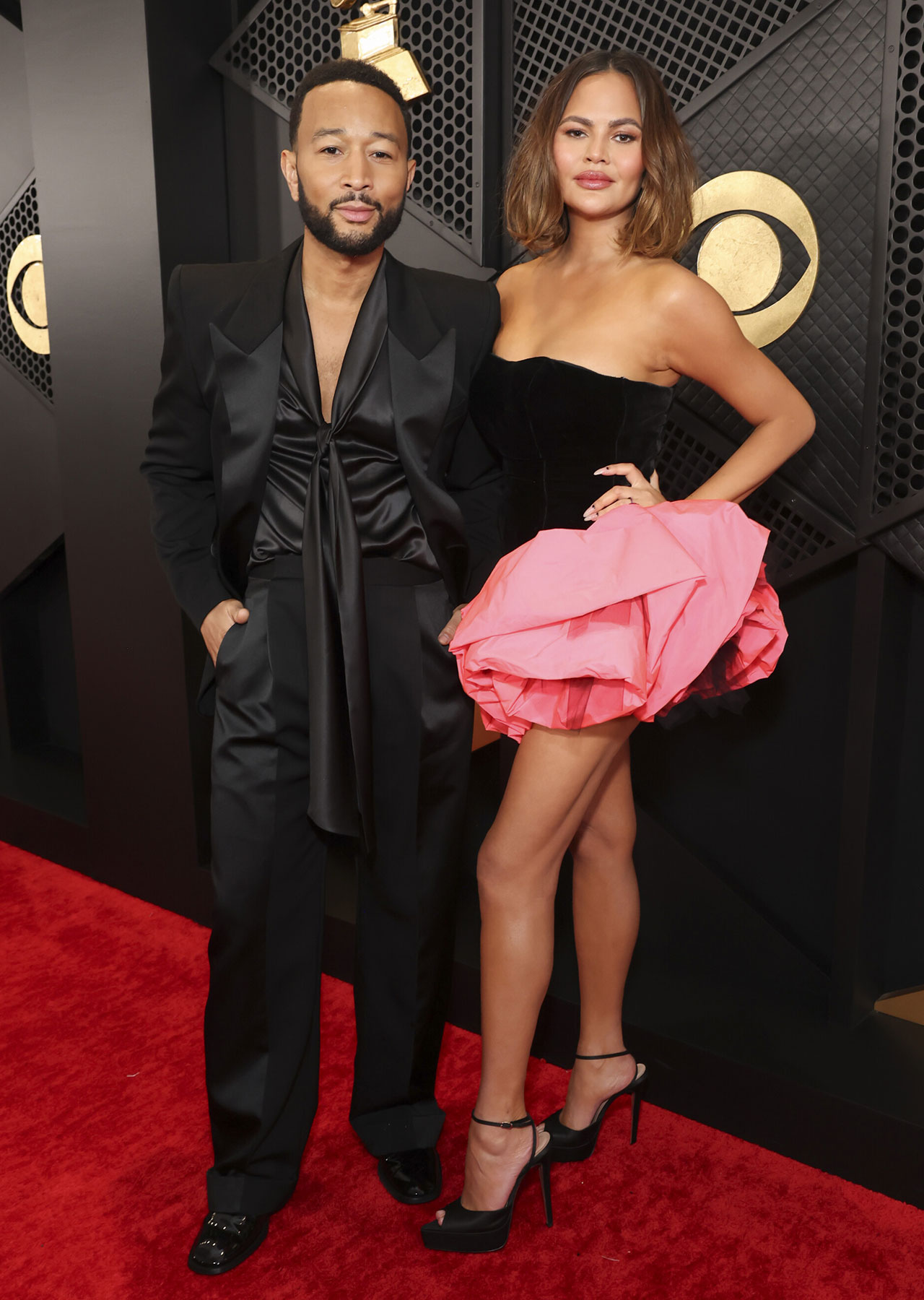 Chrissy Teigen Puts On A Leggy Display At The Grammys In A Pink & Black