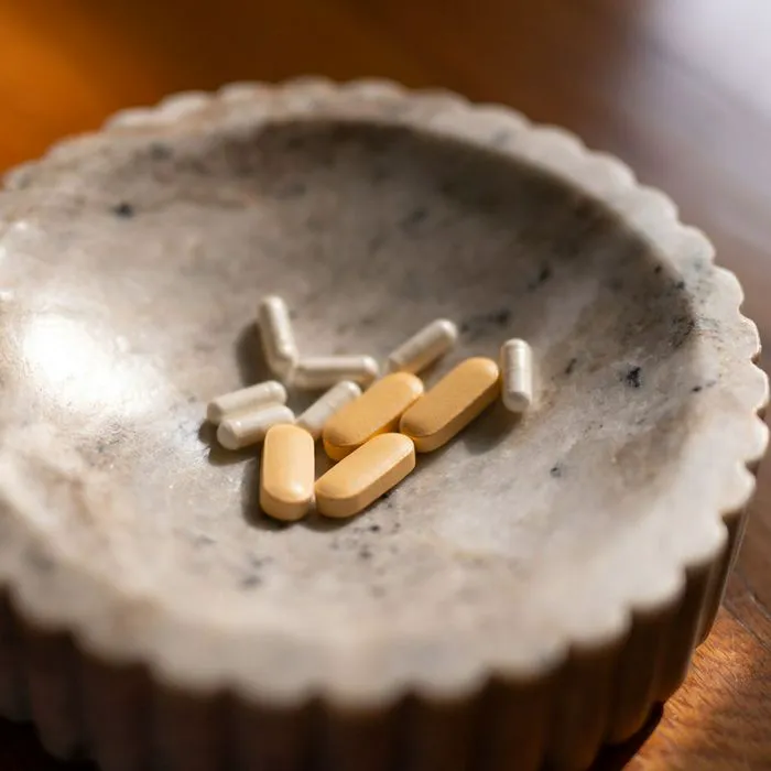 "Various dietary supplements on a marble dish"
