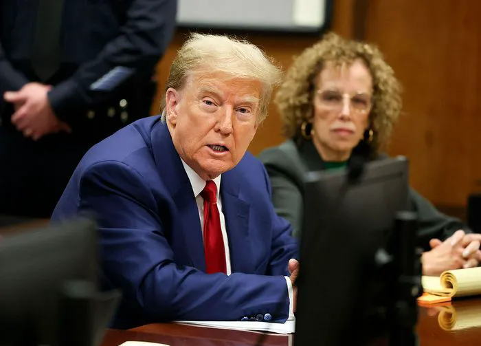 Donald Trump sits with lawyer Susan Necheles in court March 25 2024