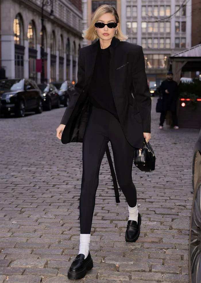 Gigi Hadid wearing white socks and black loafers, bob haircut, NYC.