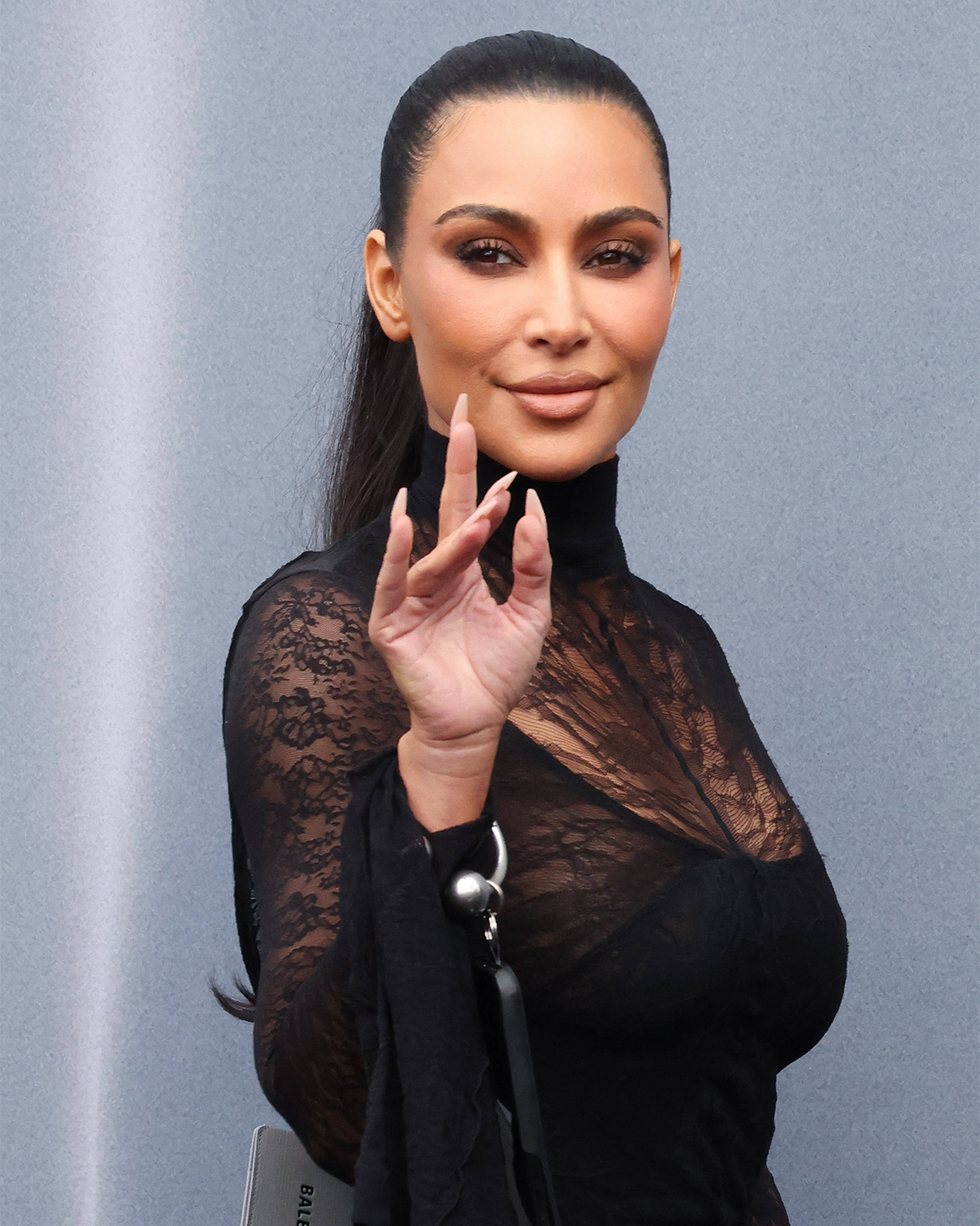 Kim Kardashian wrinkled hand waving Balenciaga FW24 show Paris Fashion Week
