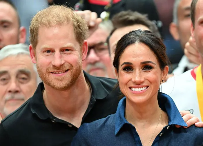 Prince Harry Meghan Markle posing for a photo