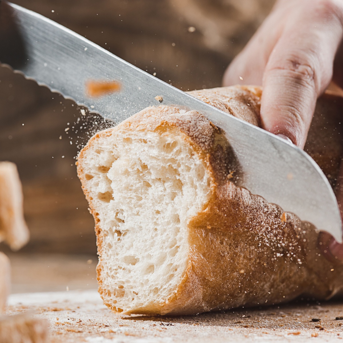person cutting bread