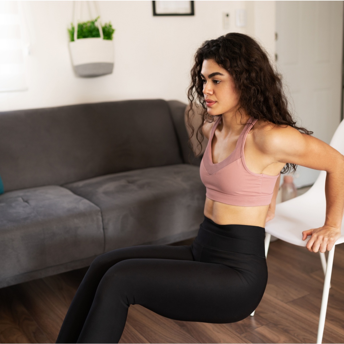 young woman doing chair dips