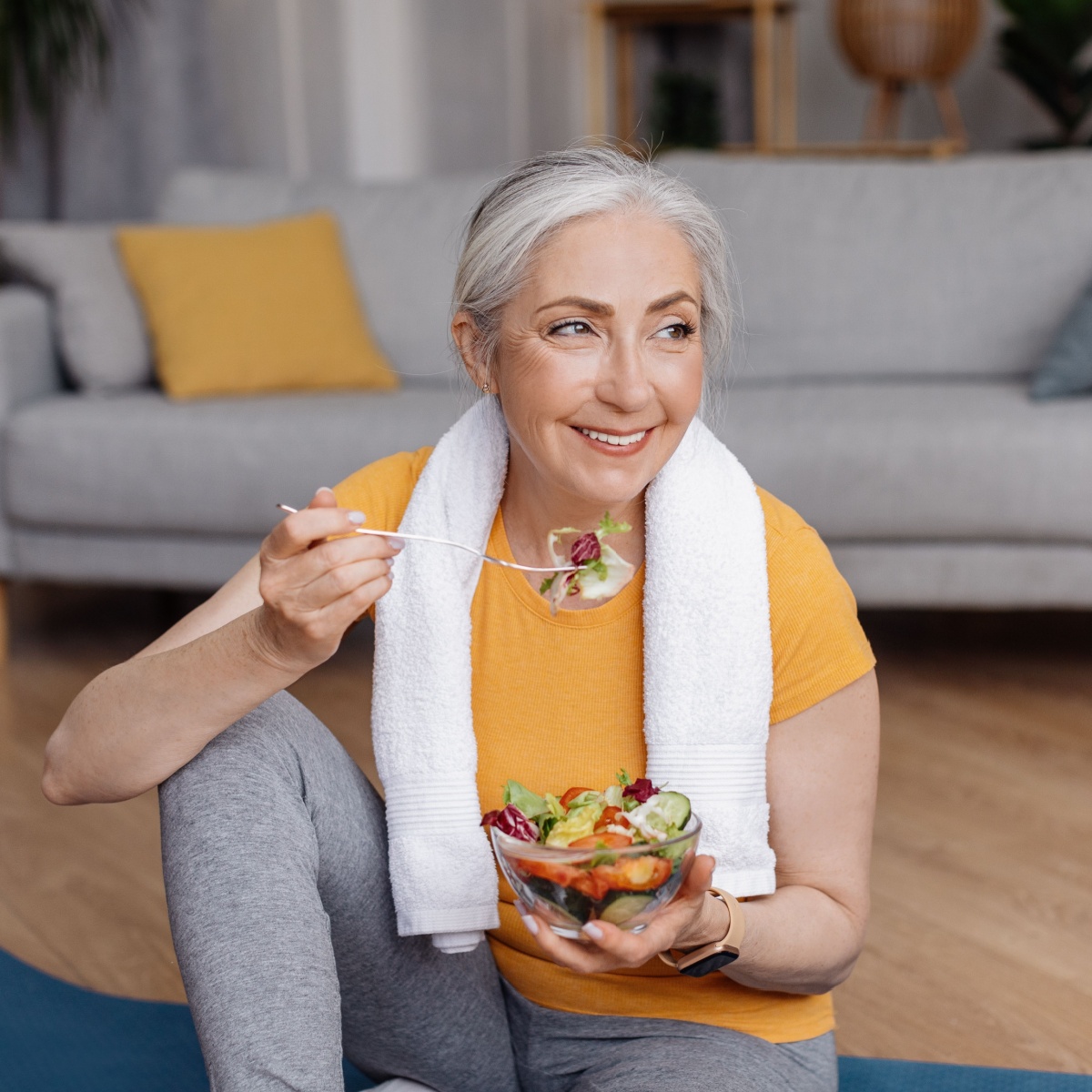 older woman eating salad