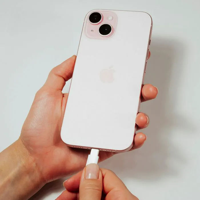 woman-plugging-pink-iphone