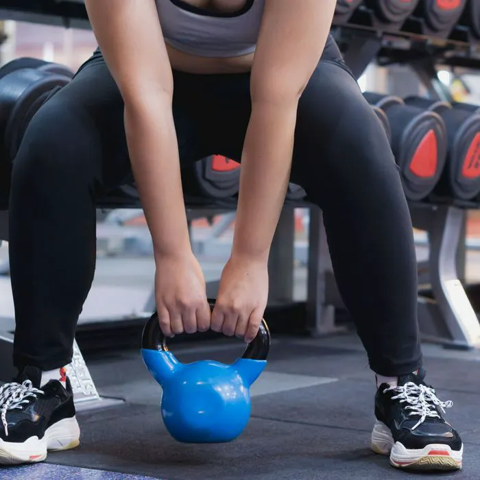 woman doing sumo squats with kettlebell