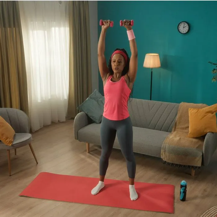 woman raising dumbbells over head