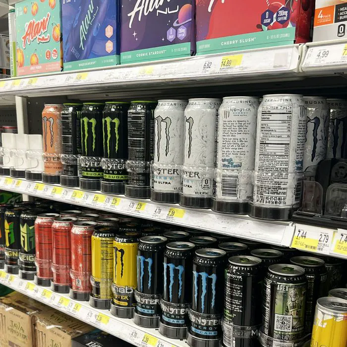 "Cans of energy drinks on supermarket shelves"