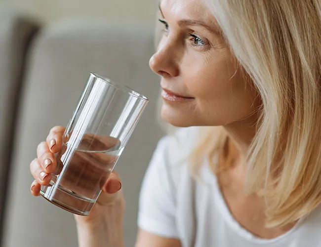 woman drinking a glass of water