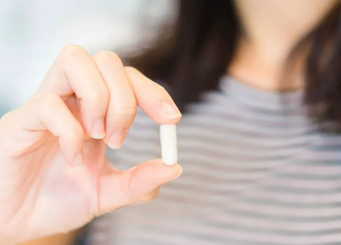 woman-holding-pill