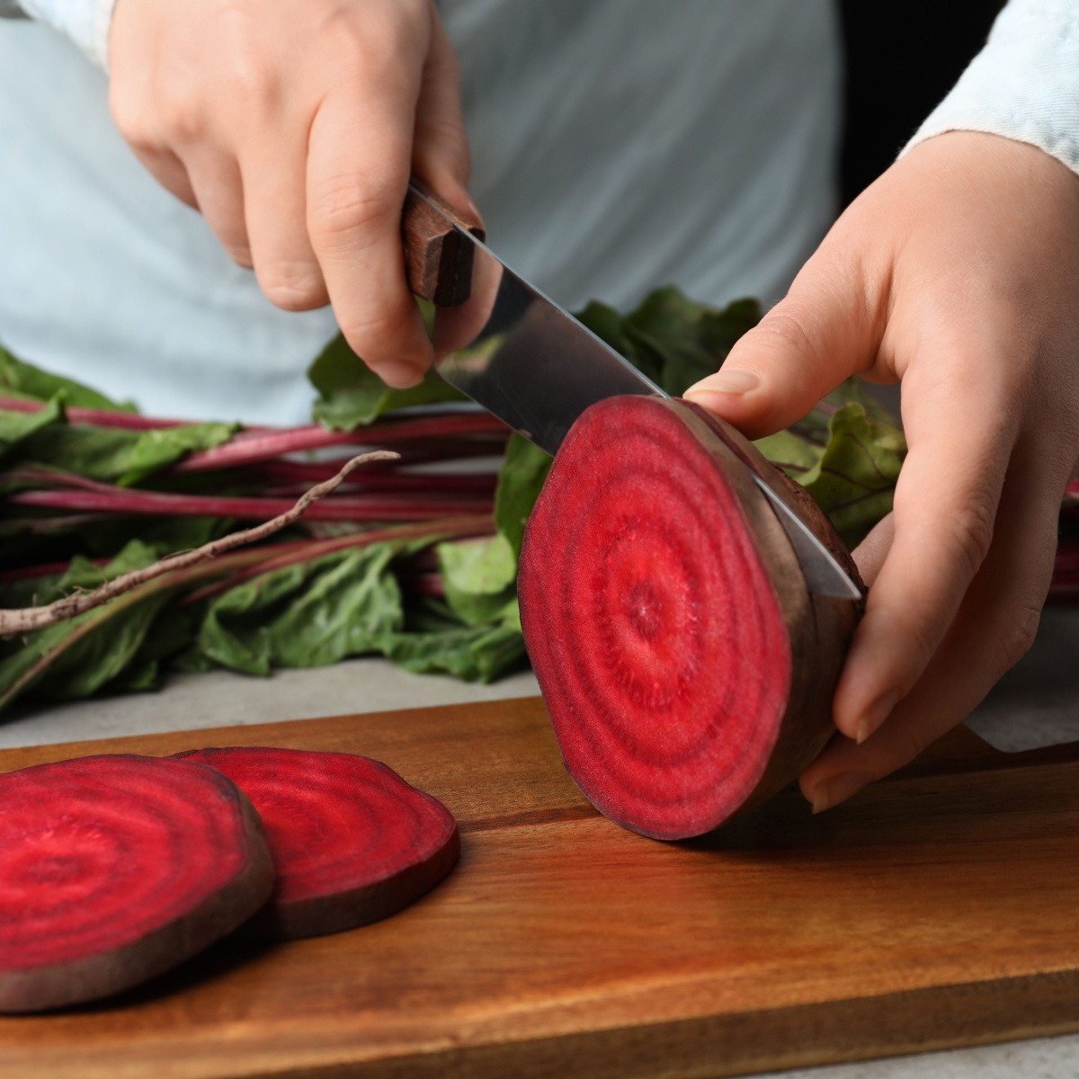 person cutting beets