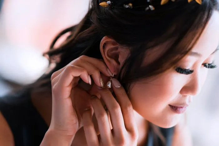 Elegant pearl earrings enhancing seasonal fashion style.