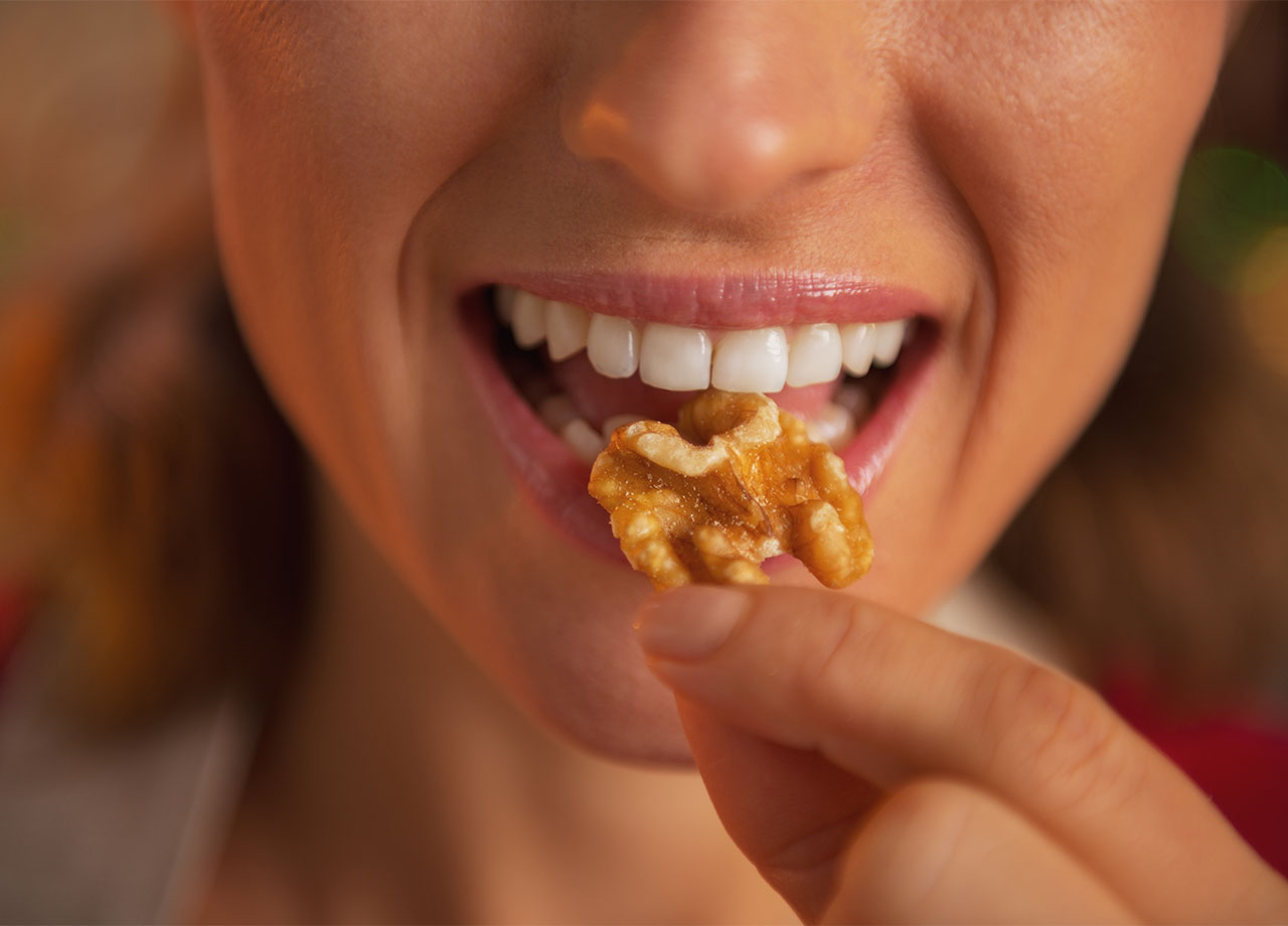 woman eating walnuts