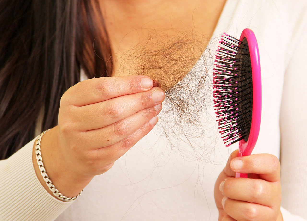 woman-pulling-clumps-hair-brush
