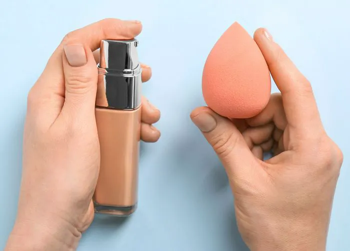 woman-holding-foundation-sponge