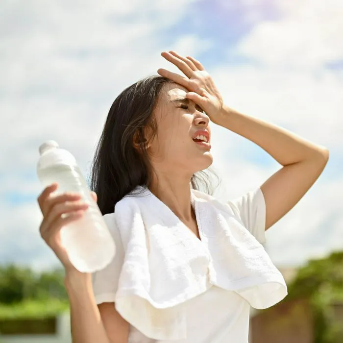 woman wiping off sweat