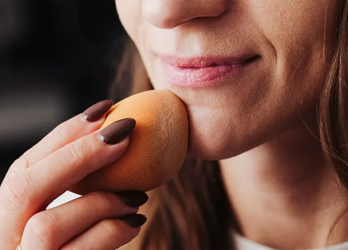 woman-applying-makeup-beauty-blender