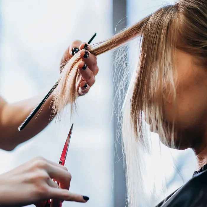 Woman giving another woman a haircut at a salon