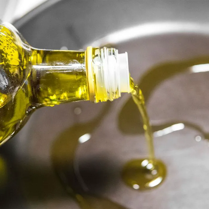 "Pouring cooking oil into a pan"