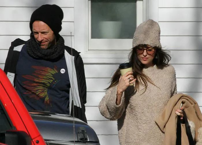 Dakota Johnson and Chris Martin exiting a Hamptons barber shop
