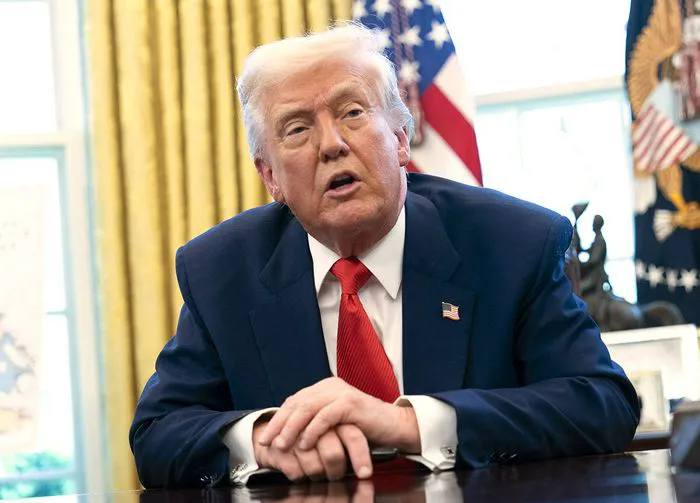 Donald Trump signing executive orders in the Oval Office, April 9.