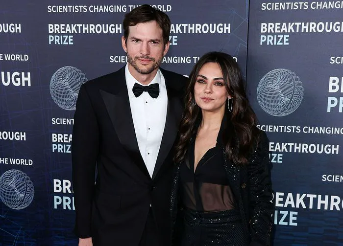 Mila Kunis and Ashton Kutcher sharing a serious moment