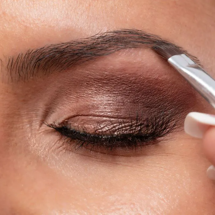 "Close-up of a woman's face showing makeup application"