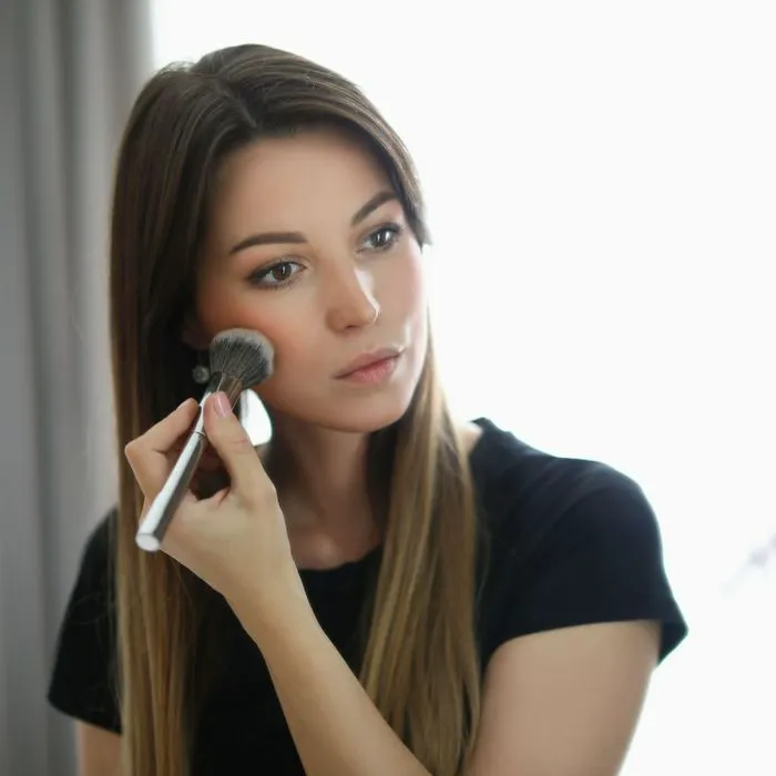 "A woman showing off flawless skin after makeup"