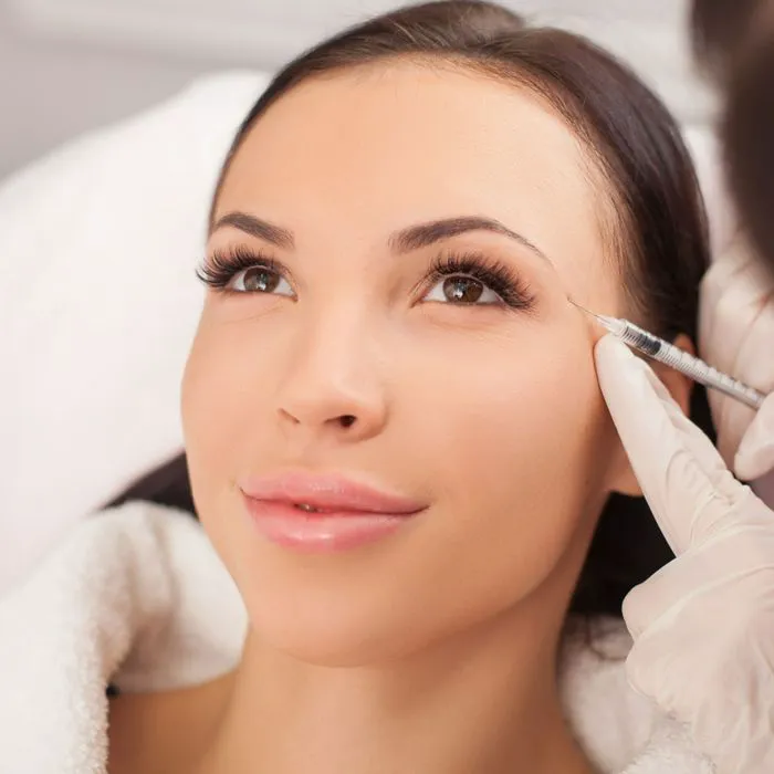 Glamorous celebrity makeup look with bold lips and defined eyes.