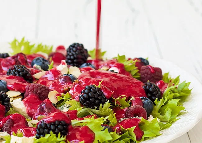dressing pouring onto salad